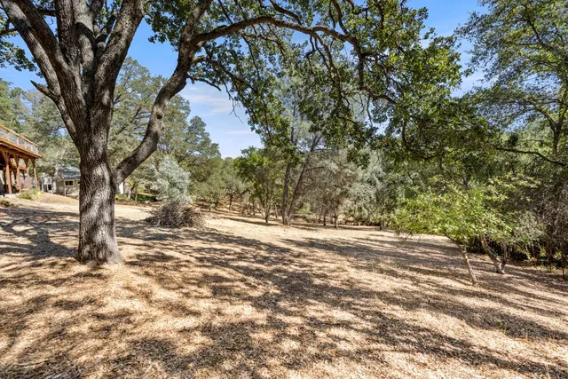 a terrace of a house with wooden floor and outdoor seating