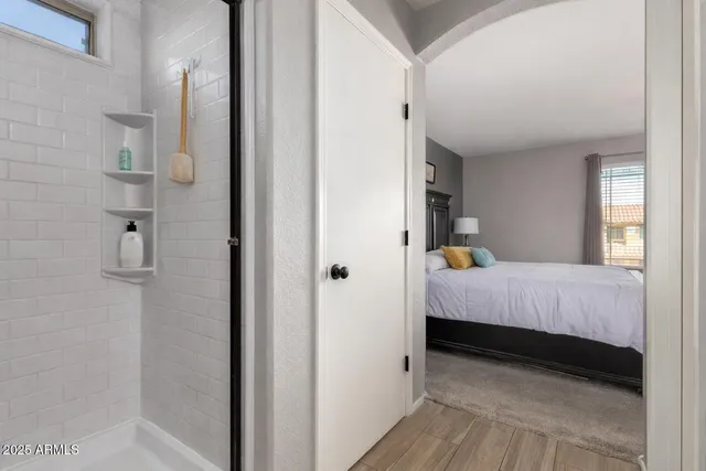 a view of a patio with table and chairs potted plants with floor to ceiling window