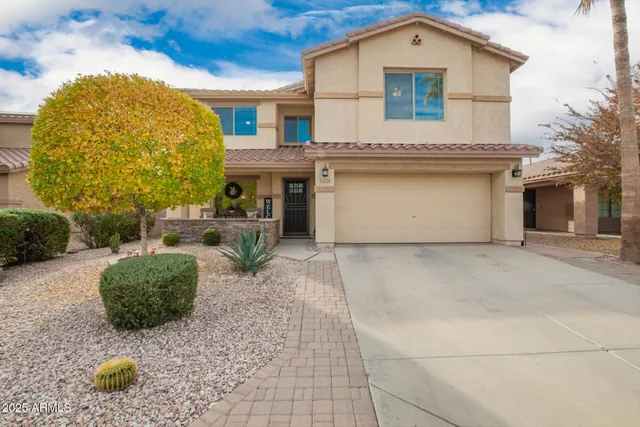 a living room with furniture and a dining table with kitchen view
