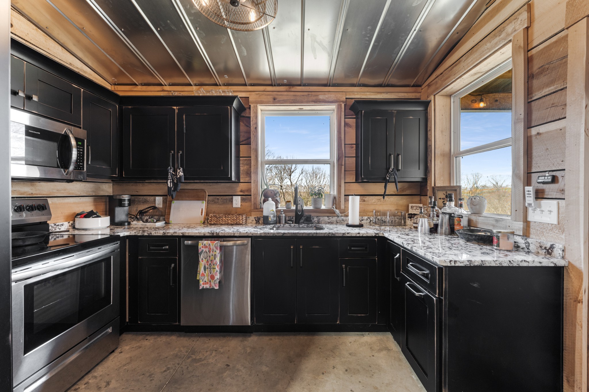 1770 Lockertsville Road Ashland City, TN 37015 - Photo 56 of 95 a kitchen with stainless steel appliances granite countertop a sink stove and cabinets