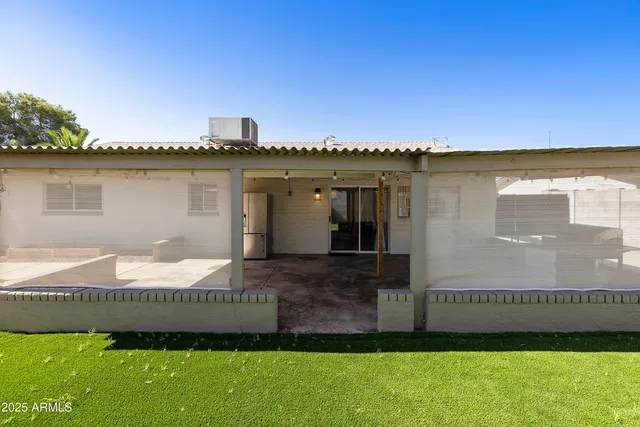 a front view of a house with a garden and yard