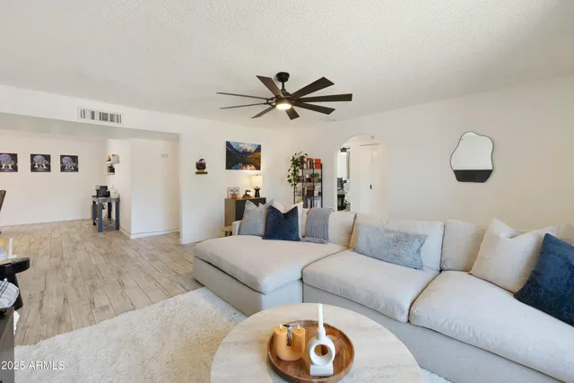 a living room with furniture and a chandelier