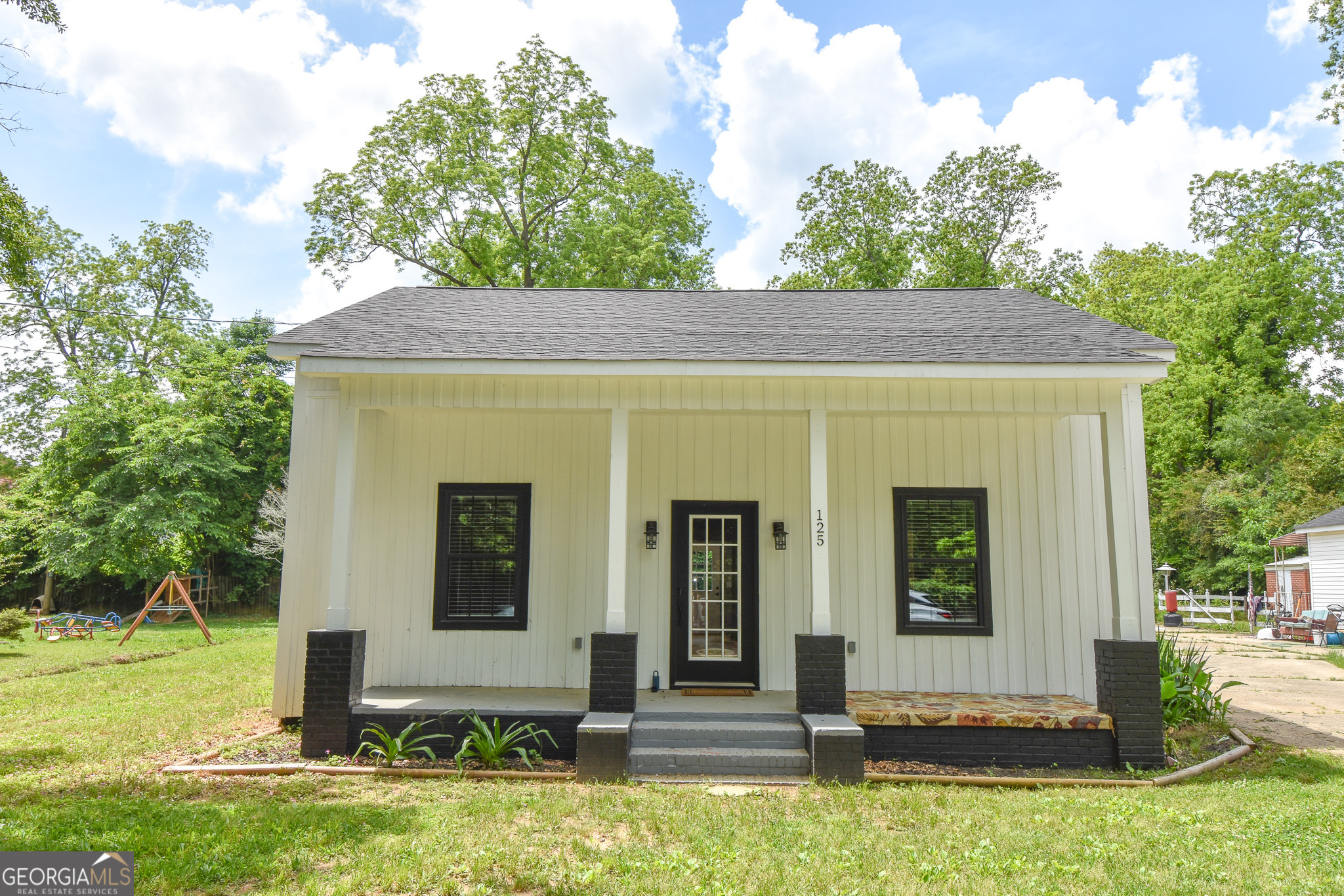 a front view of a house with garden