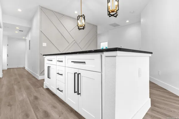 a view of kitchen with granite countertop cabinets and wooden floor