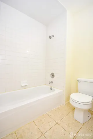 a bathroom with a toilet and a bathtub