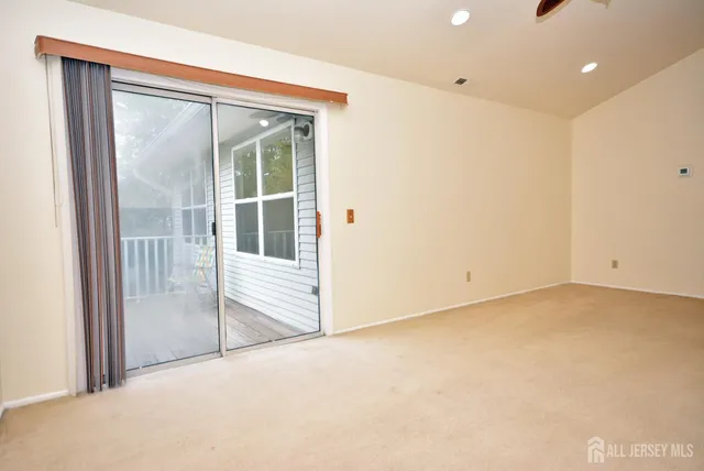 a view of an empty room with a sliding door