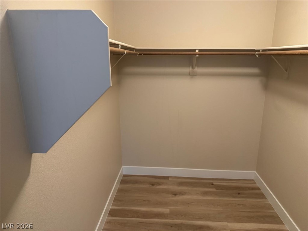 3962 Coyote Ridge Court Las Vegas, NV 89129 - Photo 26 of 35 Ample hanging space and durable flooring define this well-appointed walk-in closet.