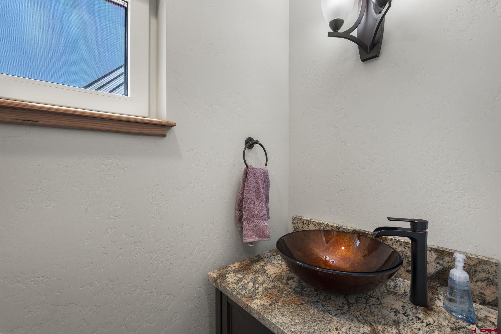 34958 Rd P.2 Mancos, CO 81328 - Photo 17 of 44 a bathroom with a granite countertop toilet and a mirror
