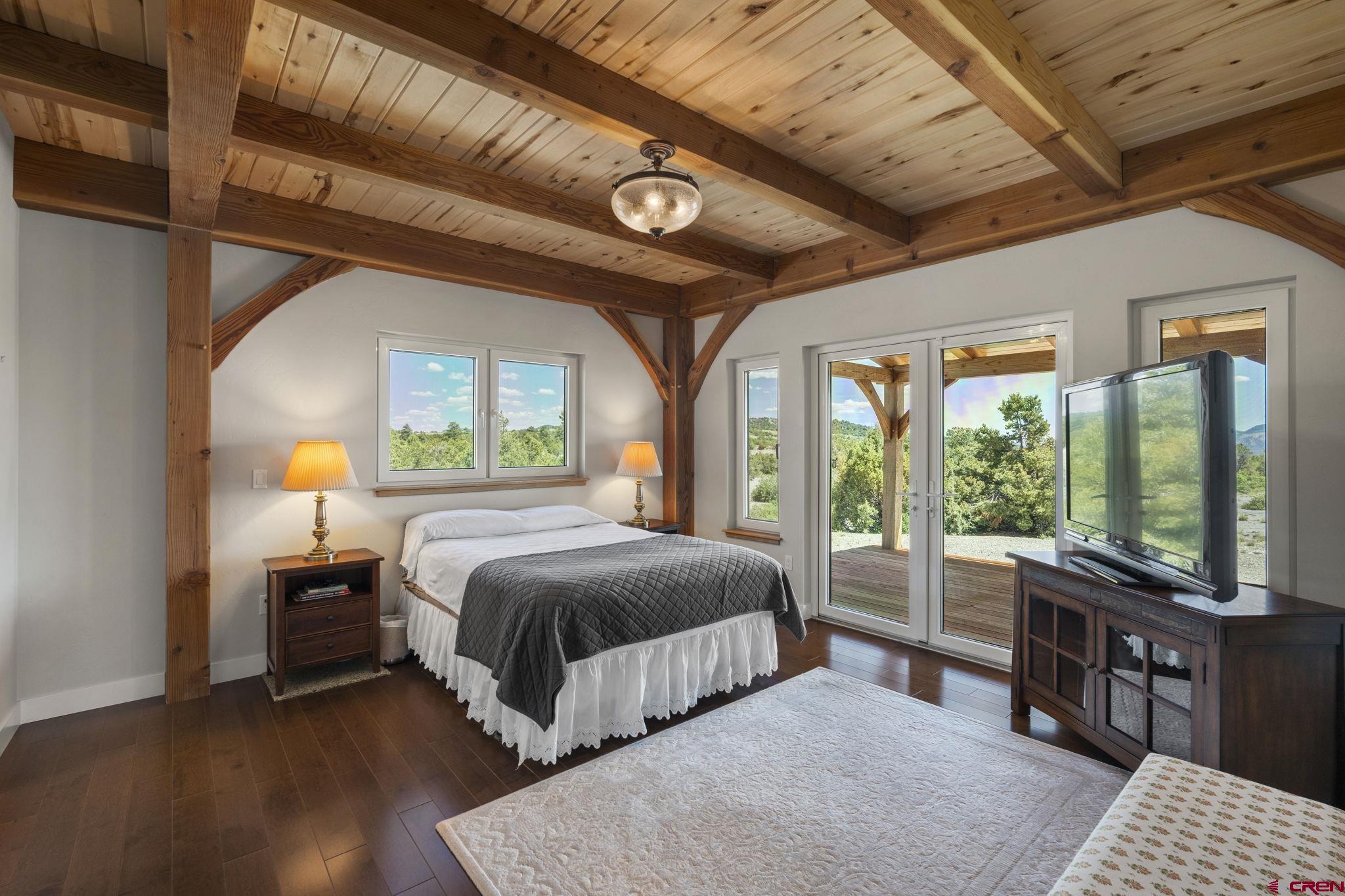 34958 Rd P.2 Mancos, CO 81328 - Photo 19 of 44 a living room with a bed furniture a fireplace and a large window
