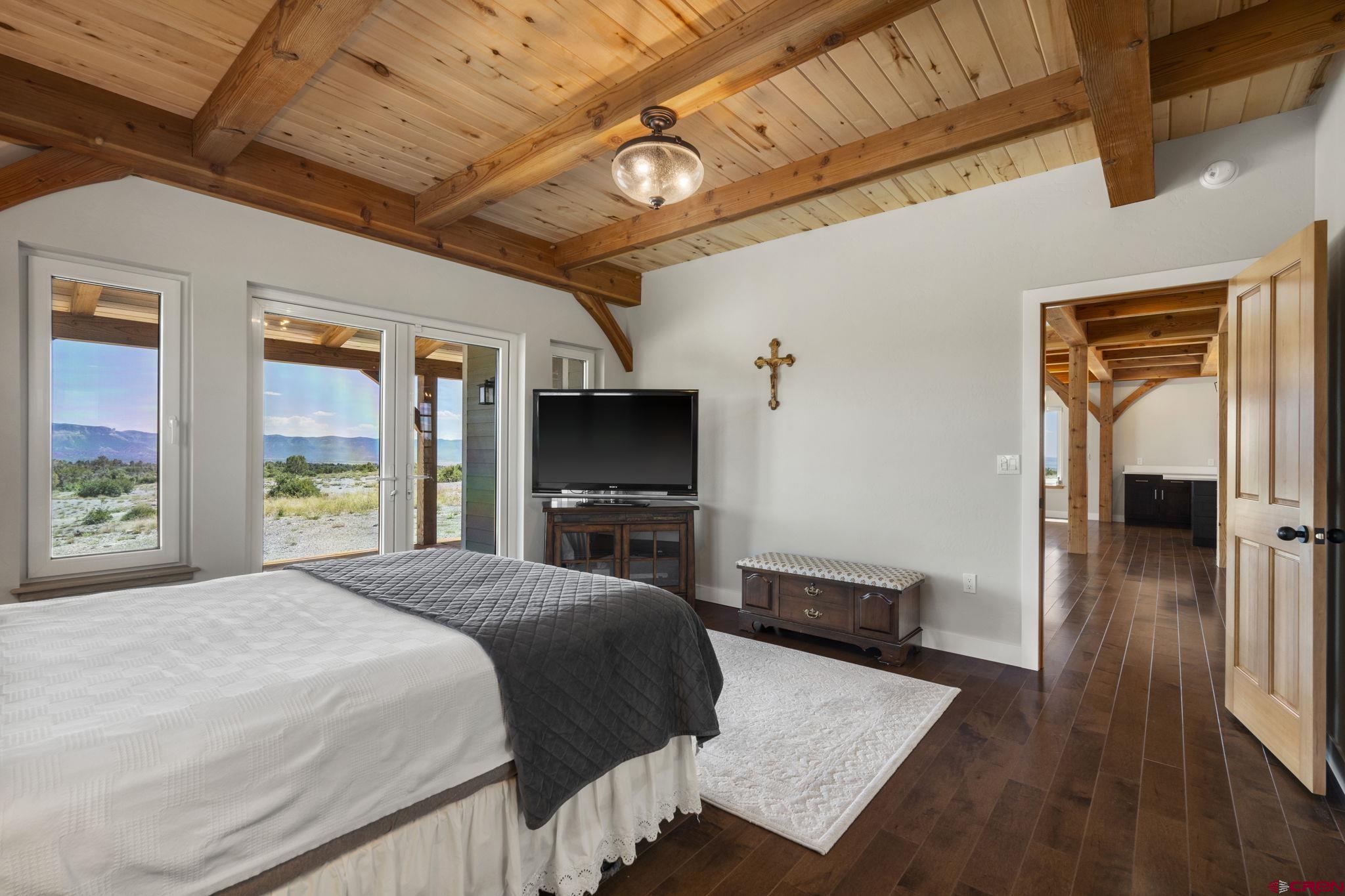 34958 Rd P.2 Mancos, CO 81328 - Photo 21 of 44 a bedroom with a bed and a flat tv screen on dresser