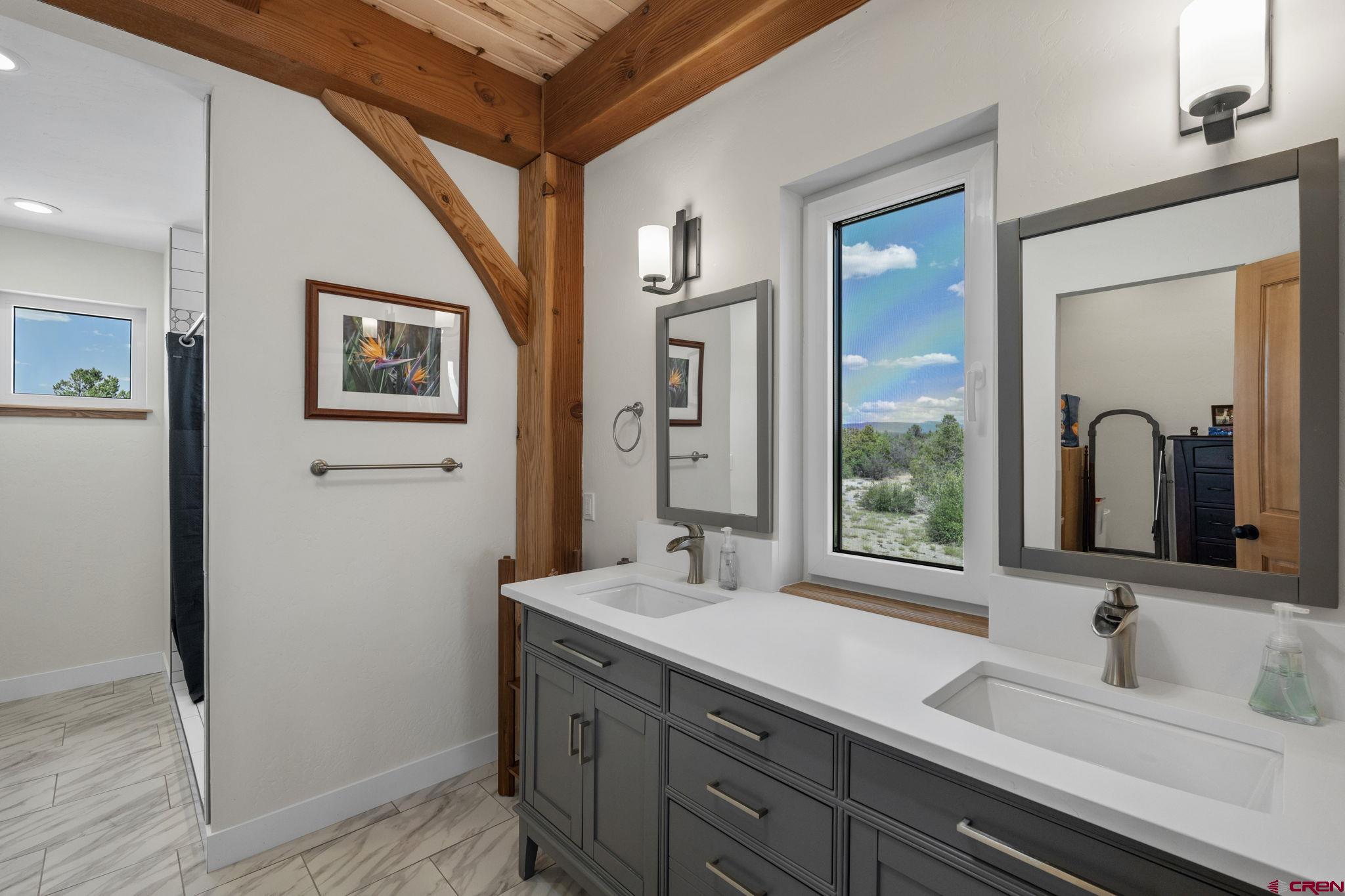 34958 Rd P.2 Mancos, CO 81328 - Photo 23 of 44 a bathroom with a double vanity sink and a mirror