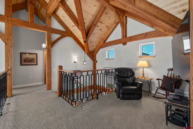 a living room with furniture a flat screen tv and a chandelier