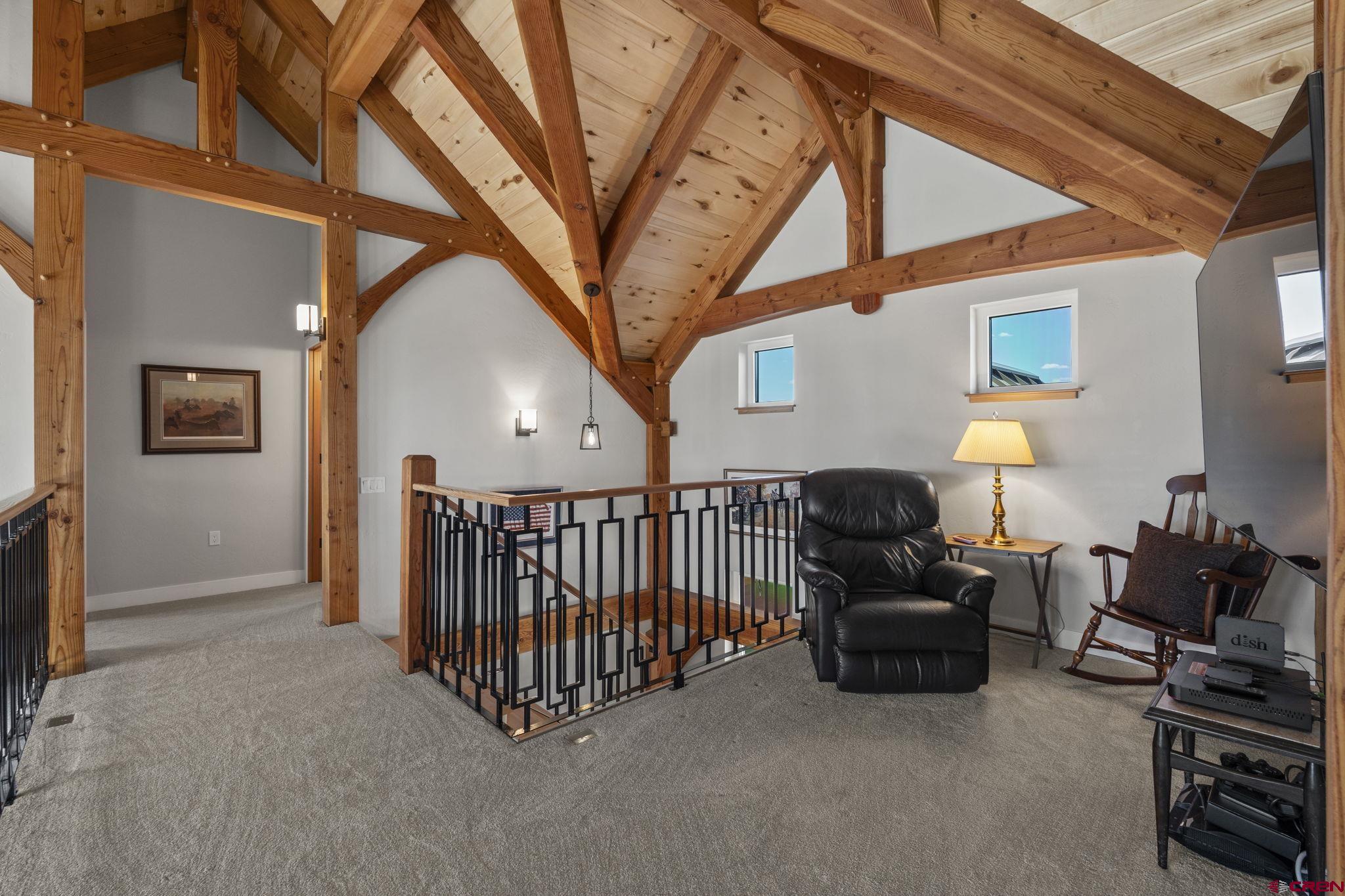 34958 Rd P.2 Mancos, CO 81328 - Photo 27 of 44 a living room with furniture a flat screen tv and a chandelier
