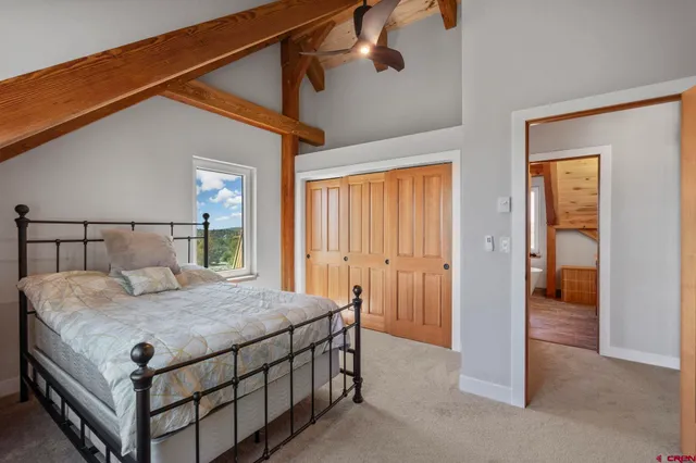 a bedroom with a bed and a table