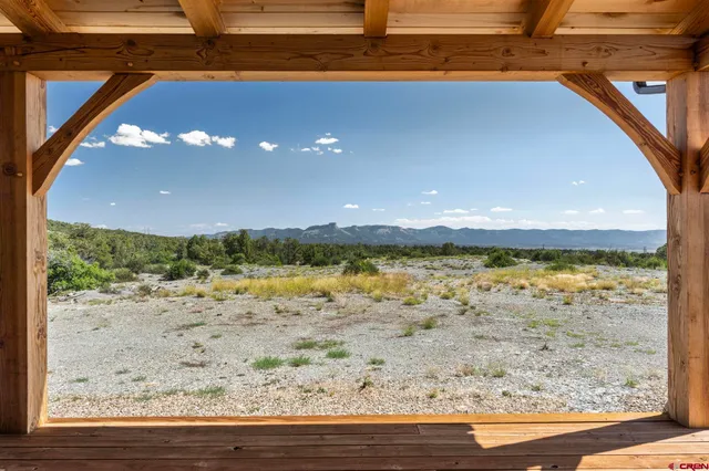 a view of a room with wooden floor and iron stairs
