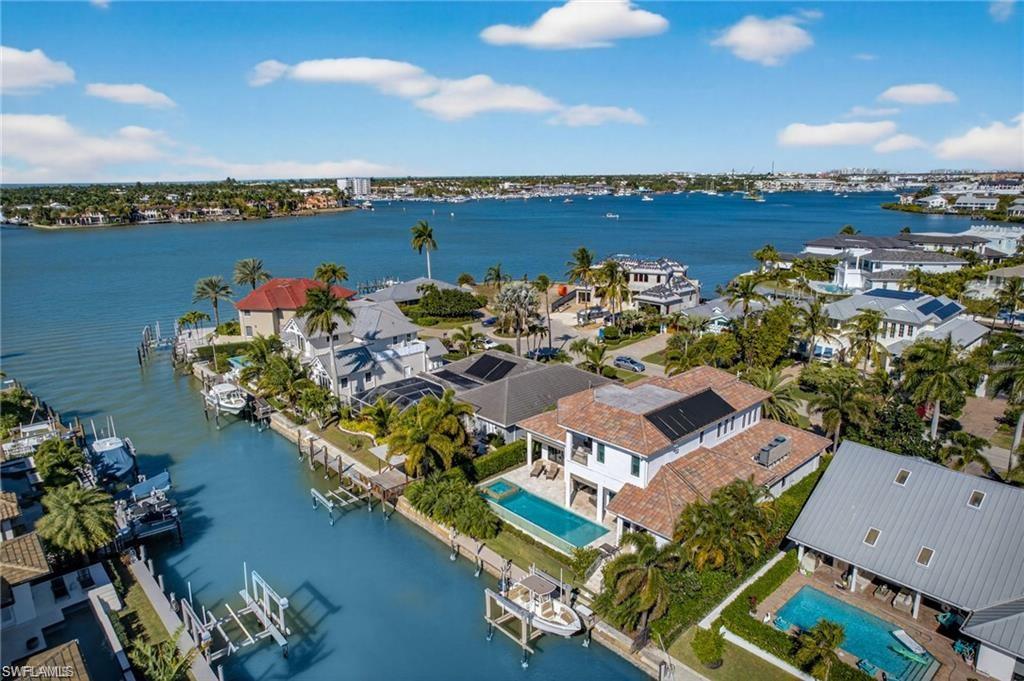 1330 Marlin Drive Naples, FL 34102 - Photo 44 of 44 Waterfront residence featuring a private pool, multiple boat slips, mature palm trees, and a tile roof