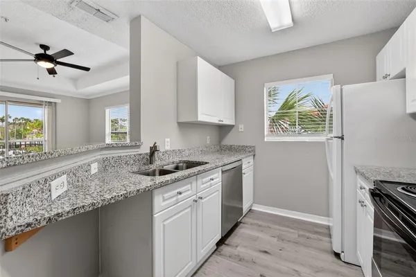 a kitchen with a sink appliances and cabinets