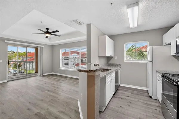 a kitchen with stainless steel appliances a stove a sink and a refrigerator