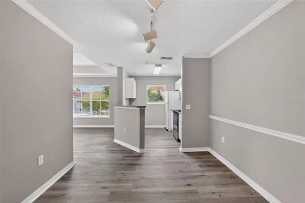 a view of a kitchen with a sink cabinets and wooden floor