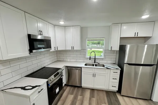 a kitchen with a sink stove and refrigerator