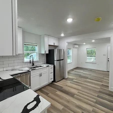 a kitchen with refrigerator and cabinets