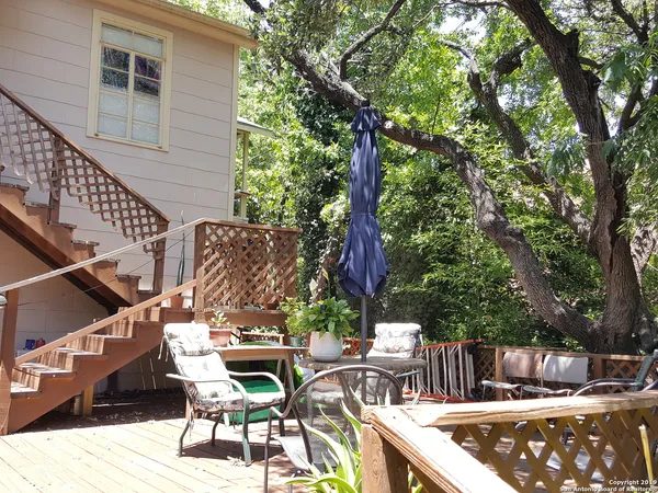 a view of a patio with iron fence
