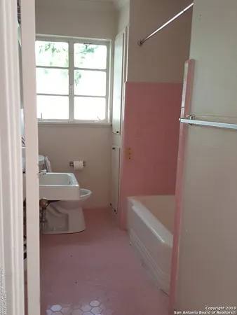 a bathroom with a sink a toilet and tub