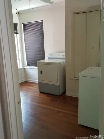 a room with wooden floor and cabinet