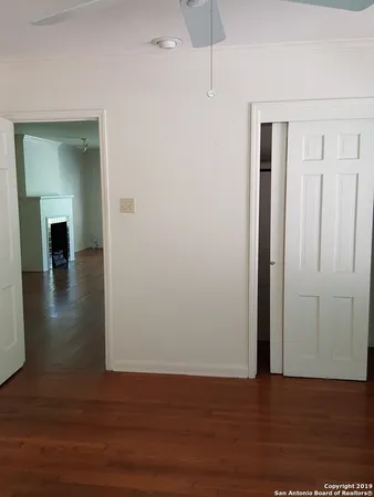 a view of empty room with wooden floor
