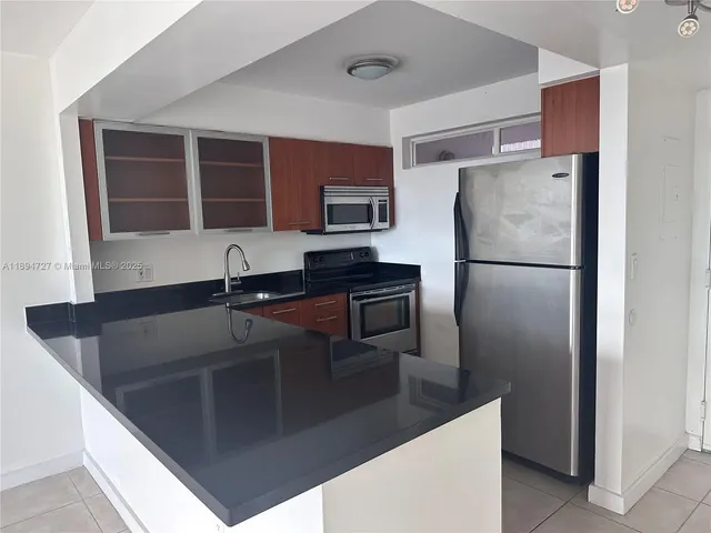 a kitchen with a refrigerator and a sink