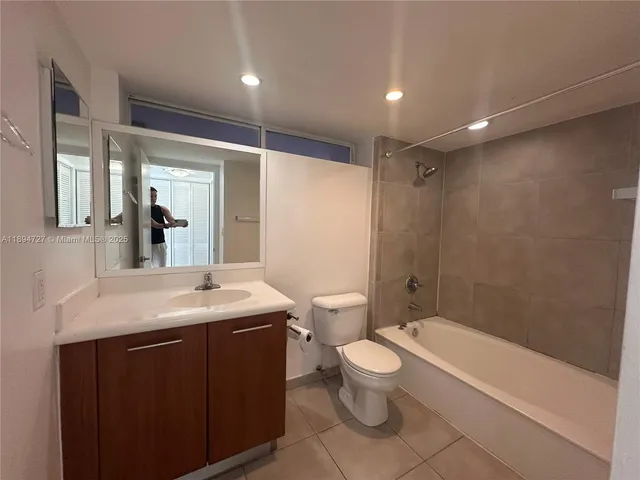 a bathroom with a bathtub a toilet a sink and mirror