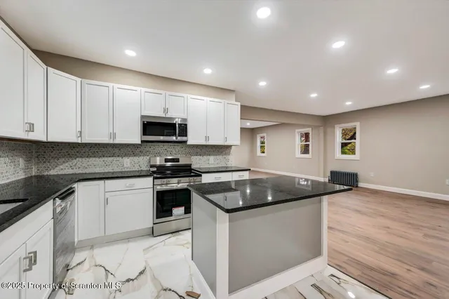 a kitchen with a sink a stove a refrigerator and cabinets