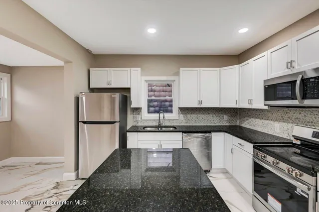 a view of a hallway with a book shelf