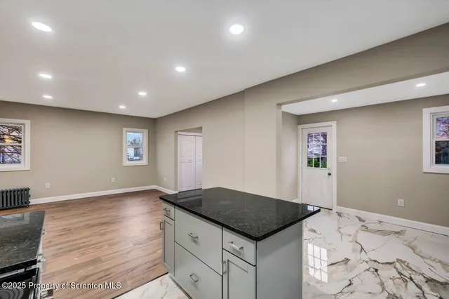 a kitchen with stainless steel appliances granite countertop a stove and a sink