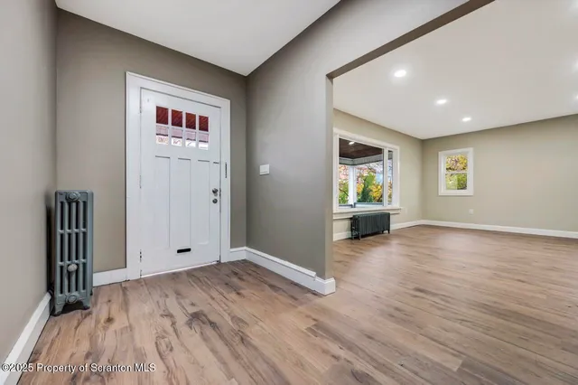 a view of an entryway with wooden floor