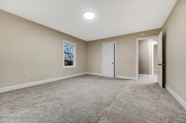 a side view of a house with large trees