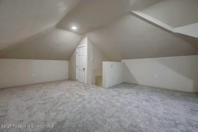 a view of a yard with plants and trees