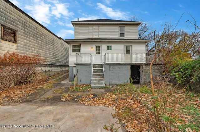 a backyard of apartments with large trees