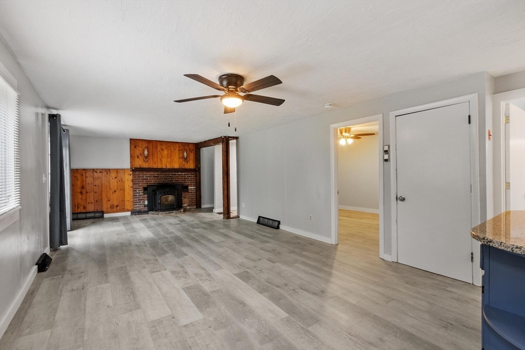 258 Allen Road Ashby, MA 01431 - Photo 12 of 36 a view of empty room with a fireplace and wooden floor