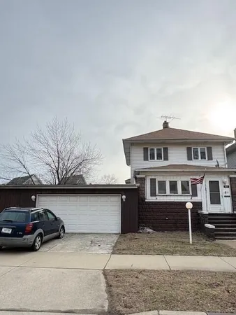 a view of a car parked in front of a house