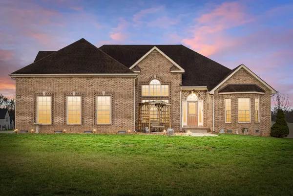 a front view of a house with a yard