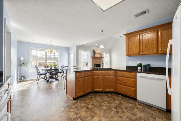 a kitchen with stainless steel appliances granite countertop a sink stove and cabinets