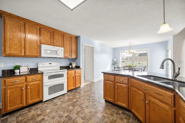 a kitchen with stainless steel appliances granite countertop a sink and cabinets