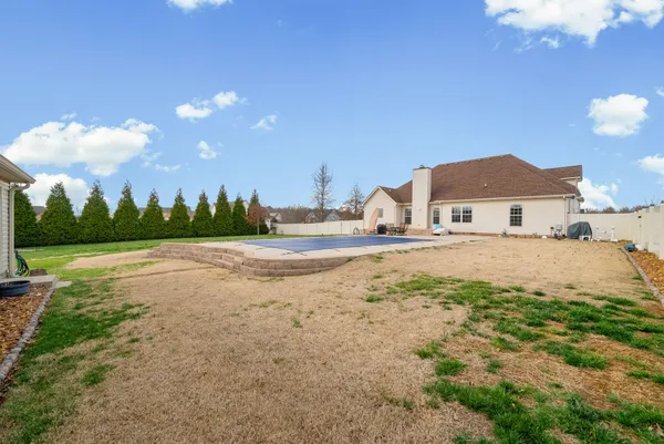 a view of a house with a yard and garage