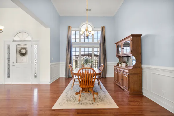a view of a dining room with furniture and chandelier