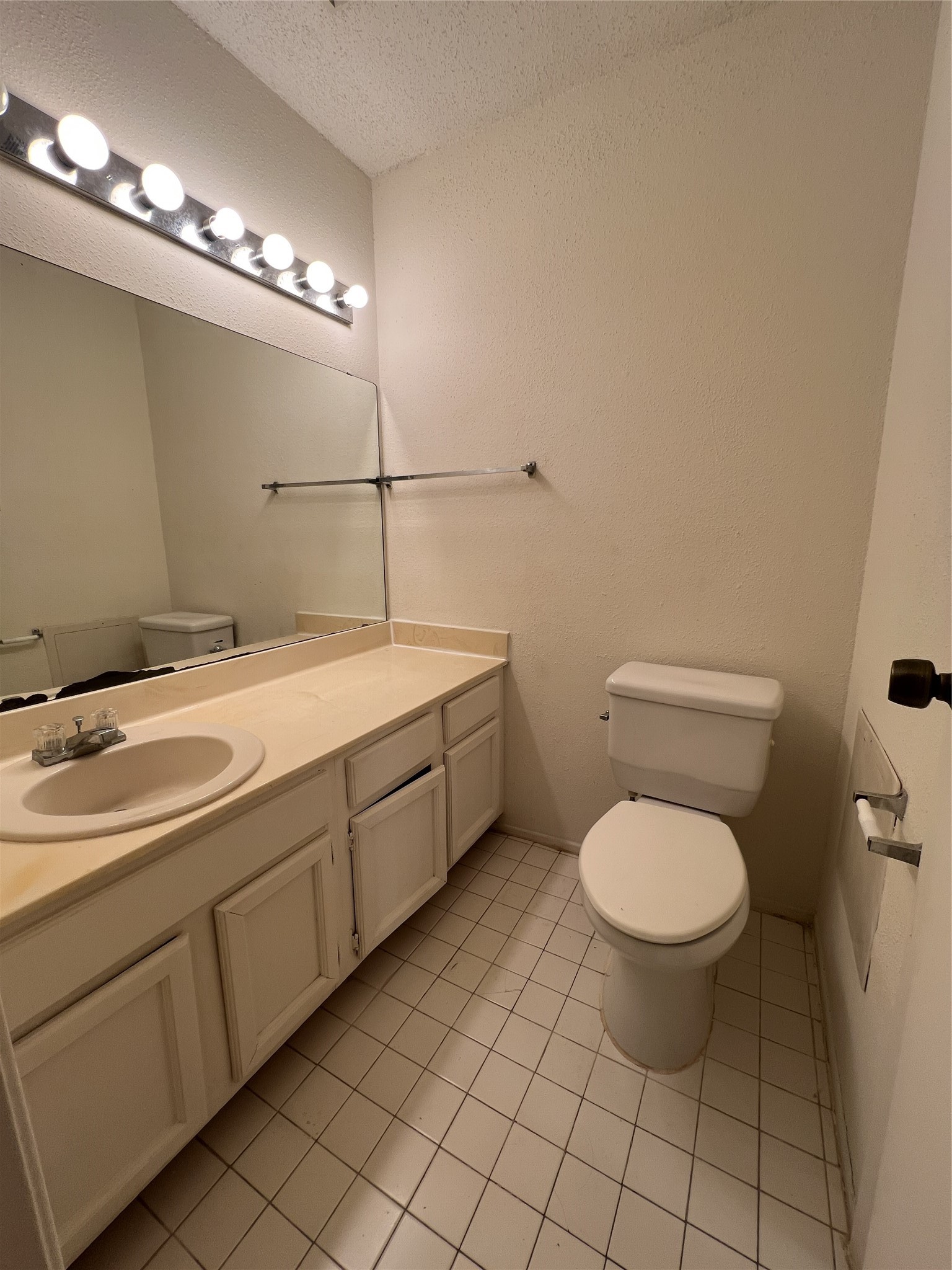 9522 Pagewood Lane, Unit 9522 Houston, TX 77063 - Photo 11 of 22 a bathroom with a toilet sink and mirror