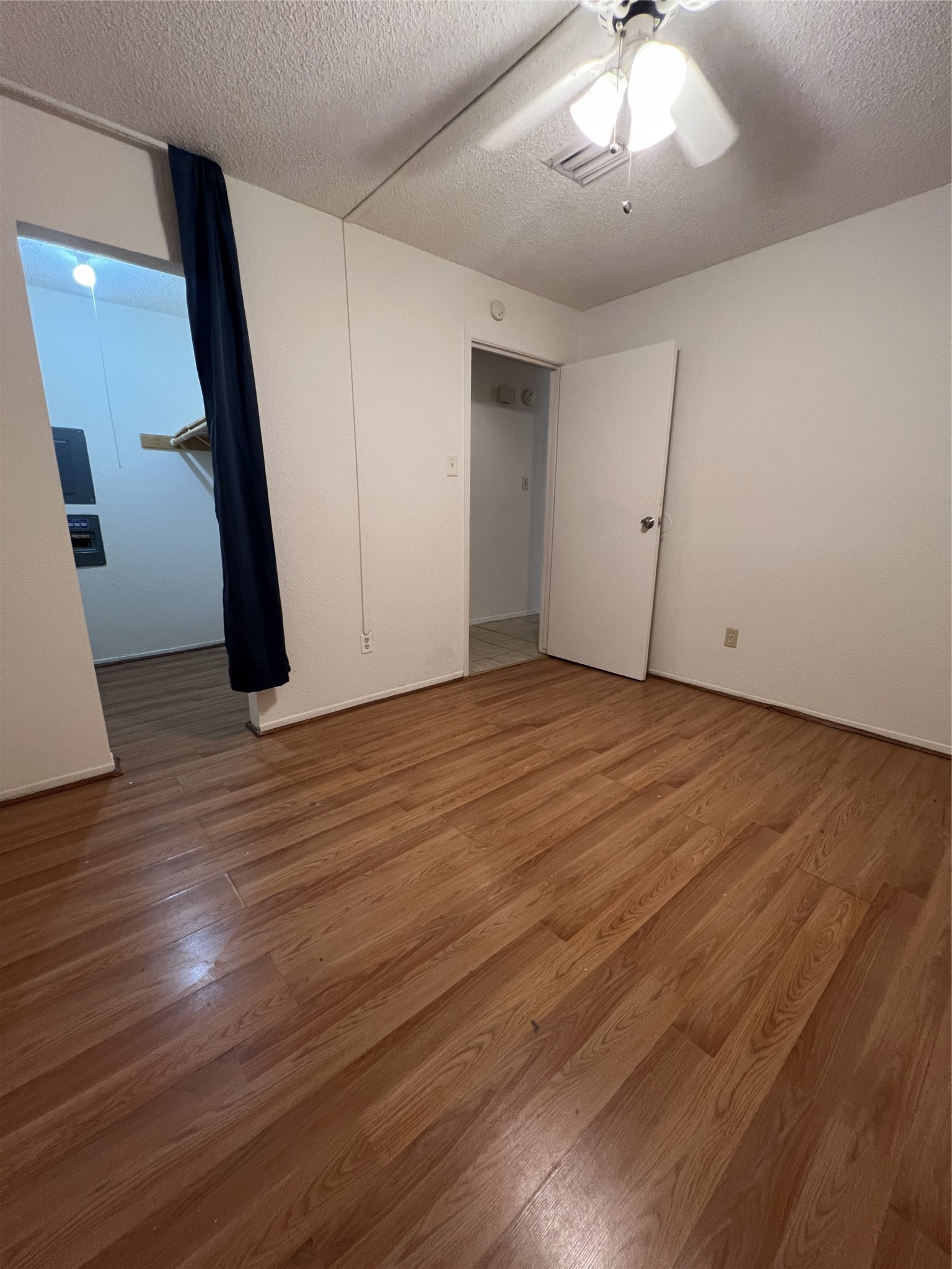 9522 Pagewood Lane, Unit 9522 Houston, TX 77063 - Photo 13 of 22 an empty room with wooden floor and staircase