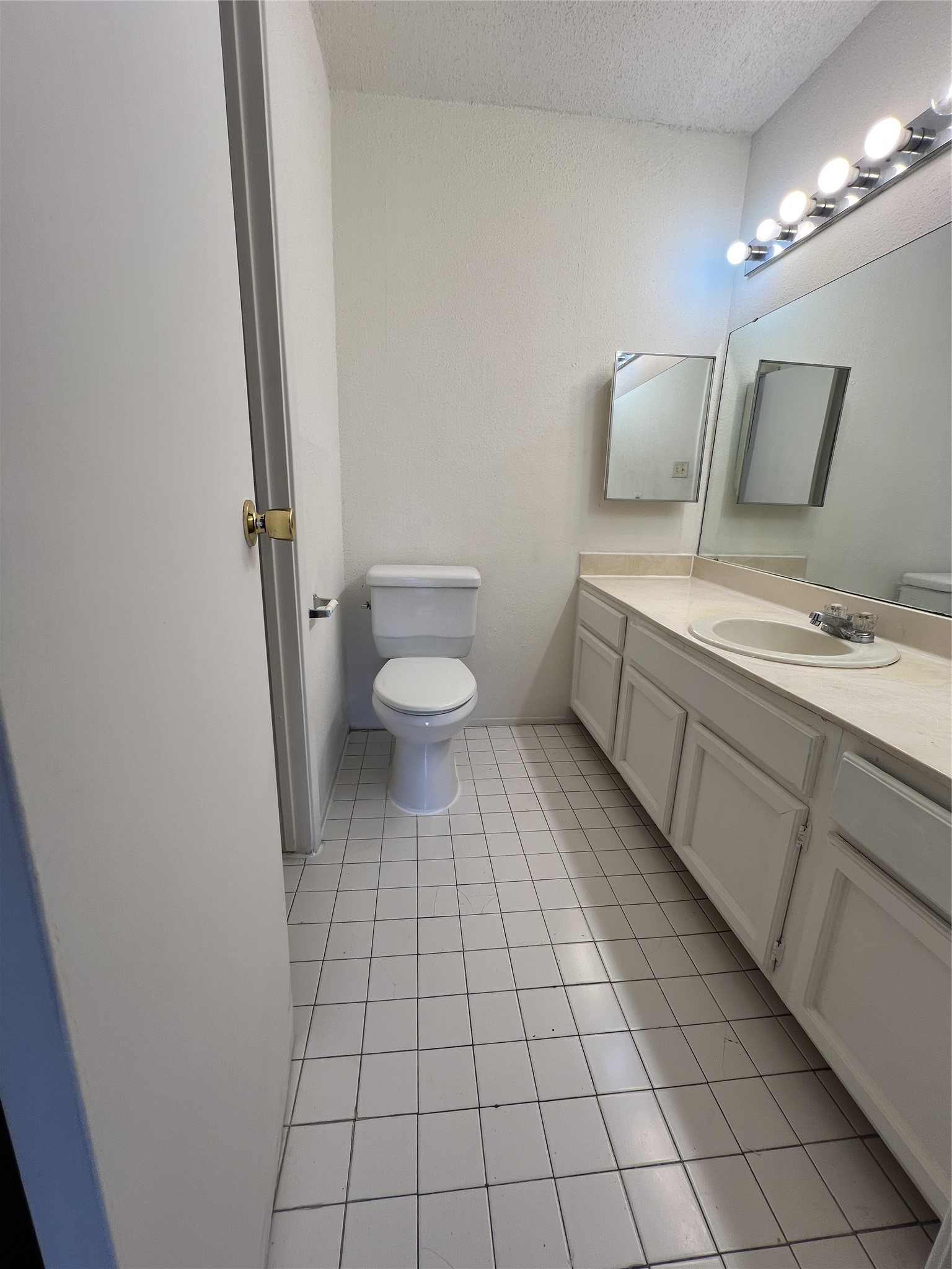 9522 Pagewood Lane, Unit 9522 Houston, TX 77063 - Photo 15 of 22 a bathroom with a toilet sink and mirror