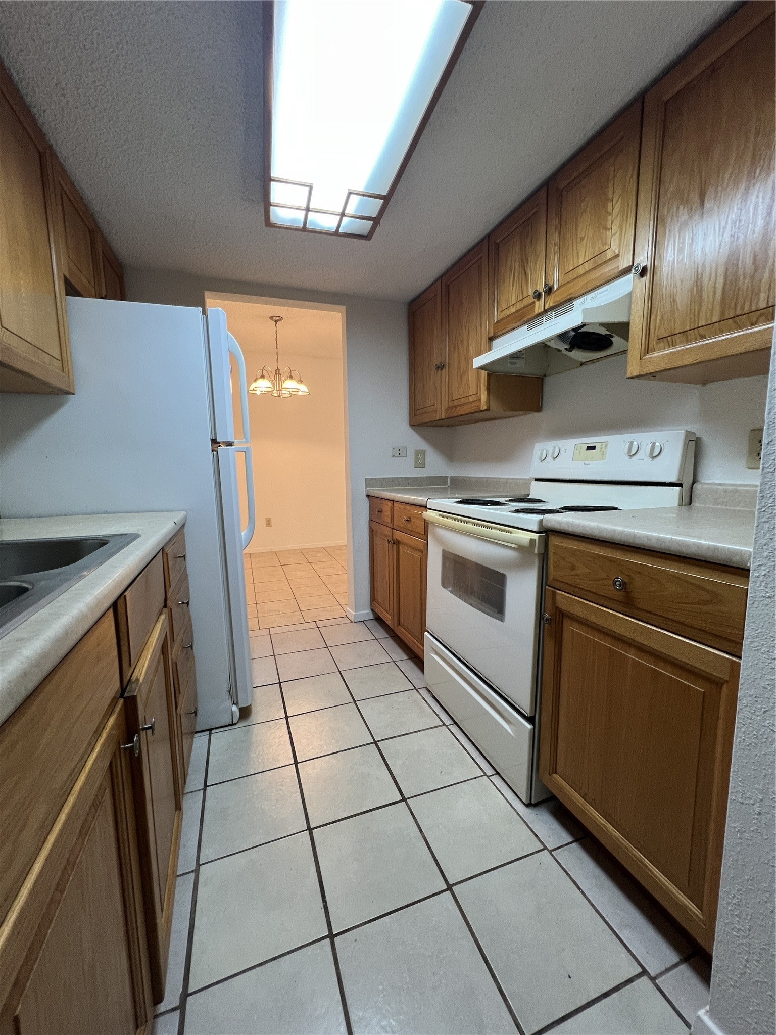 9522 Pagewood Lane, Unit 9522 Houston, TX 77063 - Photo 5 of 22 a kitchen with stainless steel appliances granite countertop a stove a sink and a refrigerator