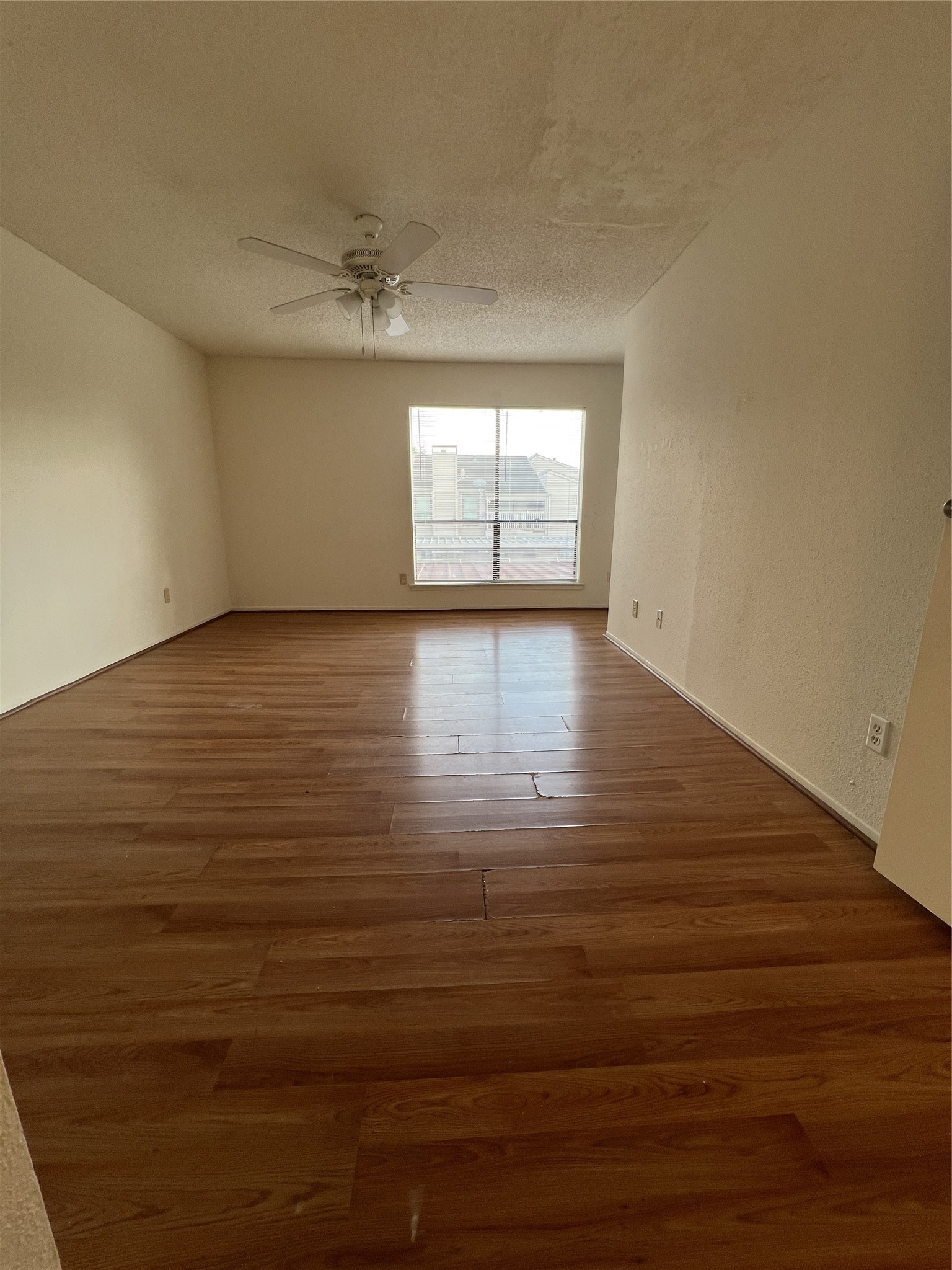9522 Pagewood Lane, Unit 9522 Houston, TX 77063 - Photo 7 of 22 a view of empty room with wooden floor and fan